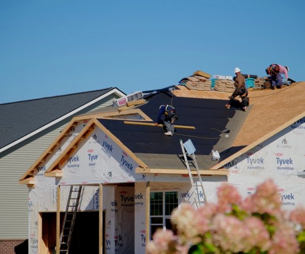 roofers-installing-a-new-roof-on-an-building-chicago-il-usa-12-sep-2023-SBI-349528244 Roofing Company in Chicago